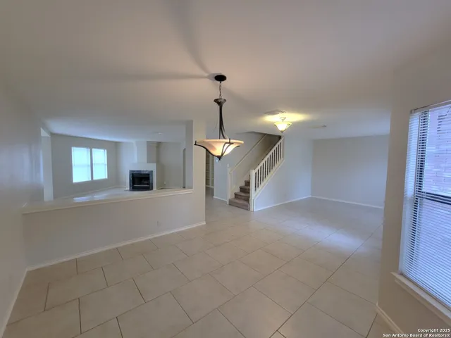 a view of a livingroom with a ceiling fan and window