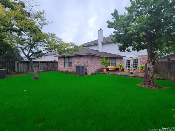 a front view of a house with a yard table and chairs