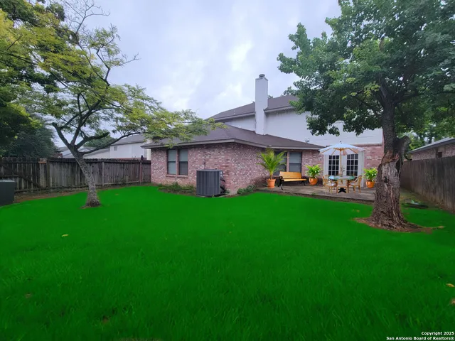 a front view of a house with a yard table and chairs