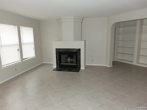 an empty room with a fireplace