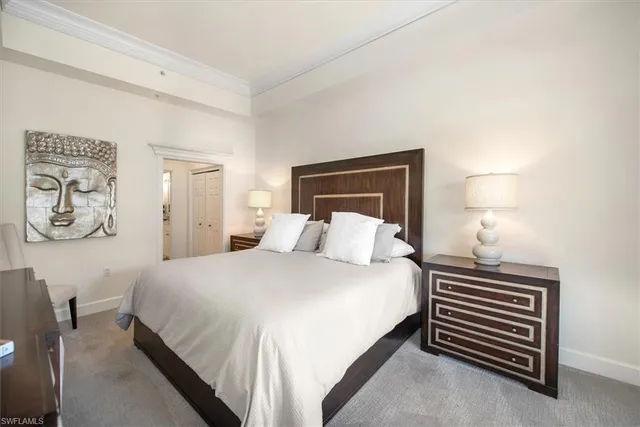 a bedroom with a bed and a night stand