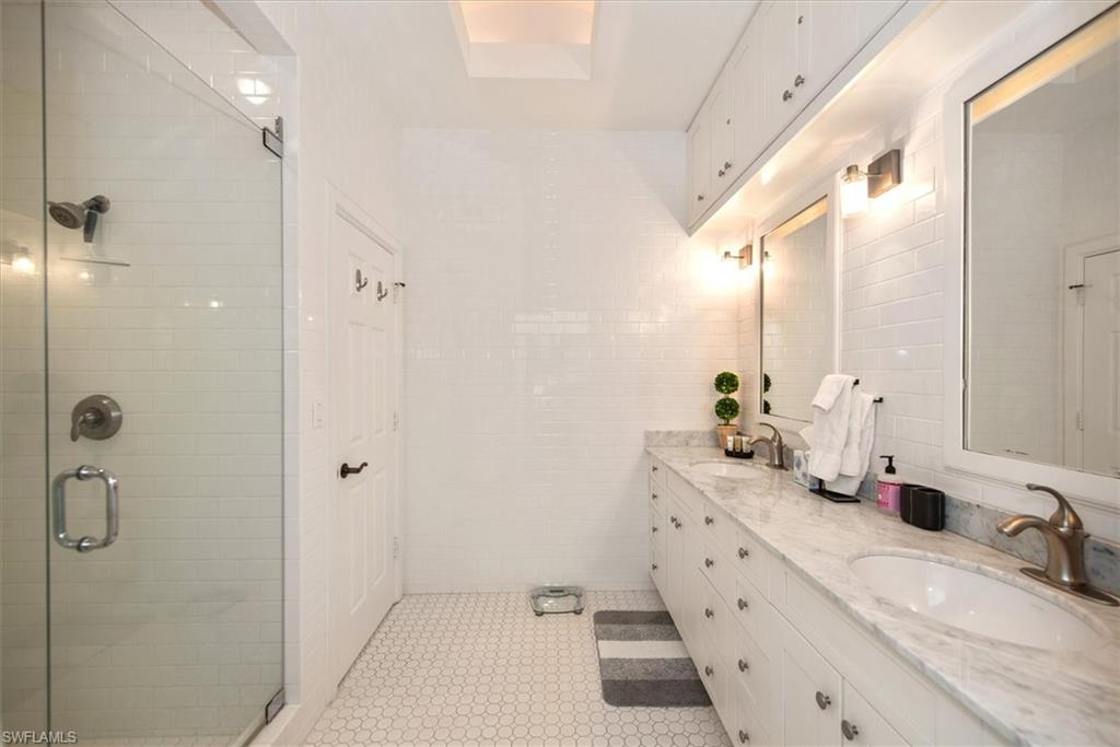 555 5th Avenue South, Unit 204 Naples, FL 34102 - Photo 21 of 30 a bathroom with double vanity and mirrors