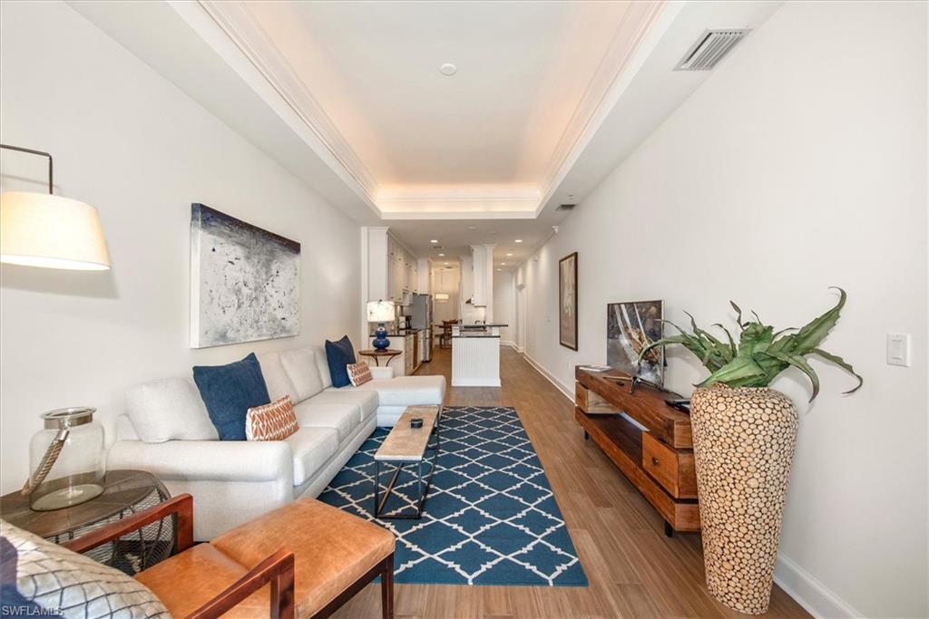 555 5th Avenue South, Unit 204 Naples, FL 34102 - Photo 6 of 30 a living room with furniture rug and a window