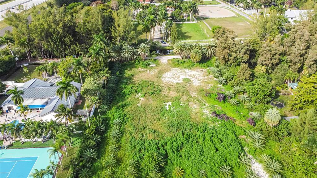 4001 Southwest 126th Avenue Miramar, FL 33027 - Photo 15 of 16 a backyard of a building with lots of green space and trees all around