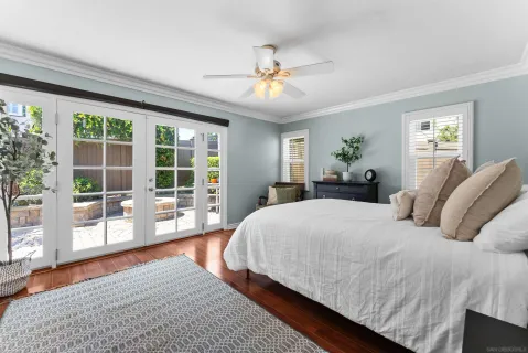 a bedroom with a large bed and a large window