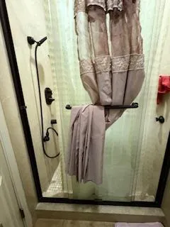 a bedroom with bed and a chandelier