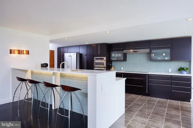 a kitchen with stainless steel appliances a sink and cabinets