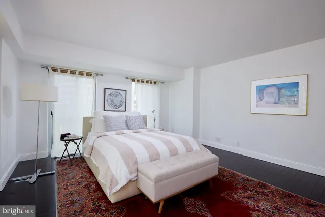 a bedroom with a large bed and a window