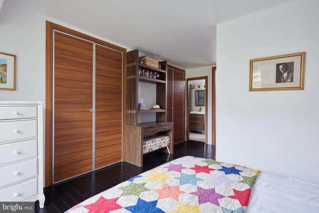 a bathroom with a shower sink vanity and toilet