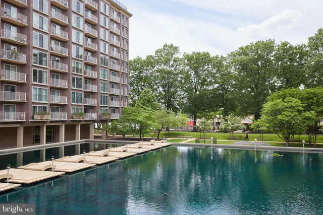 a living room with furniture a rug and a large window