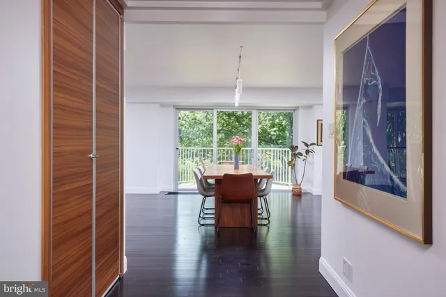 a view of a livingroom with furniture wooden floor and a window