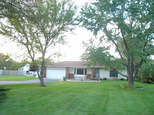 1283 Fischer Road South Beloit, IL 61080 - Photo 1 of 6 a front view of a house with yard and green space
