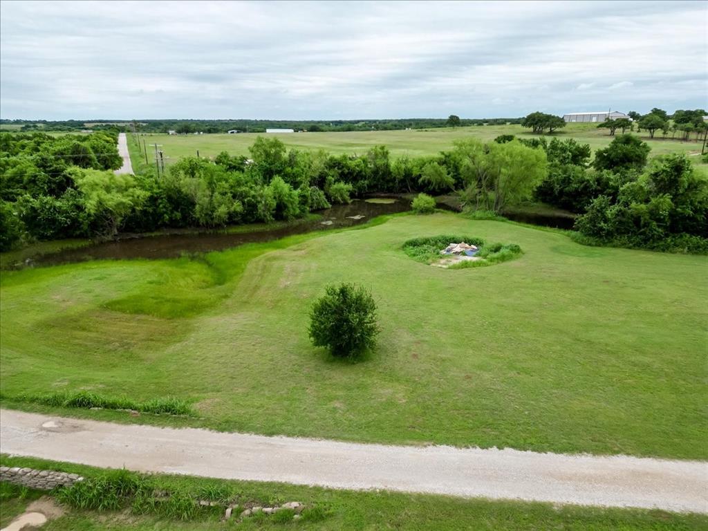 318 East Lone Star Road Poolville, TX 76487 - Photo 31 of 33 a view of a garden with an outdoor space