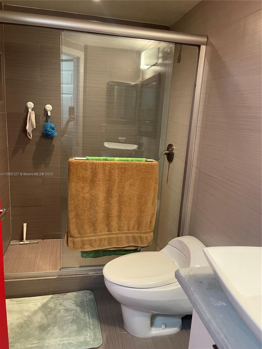 2541 Centergate Drive, Unit 205 Miramar, FL 33025 - Photo 11 of 28 a bathroom with a granite countertop bathtub shower sink and toilet