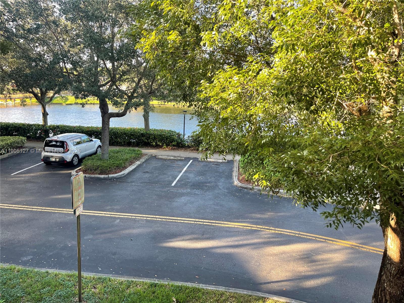 2541 Centergate Drive, Unit 205 Miramar, FL 33025 - Photo 21 of 28 a view of a street with a tree