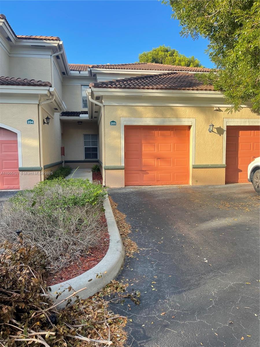2541 Centergate Drive, Unit 205 Miramar, FL 33025 - Photo 23 of 28 a view of a house with a garage