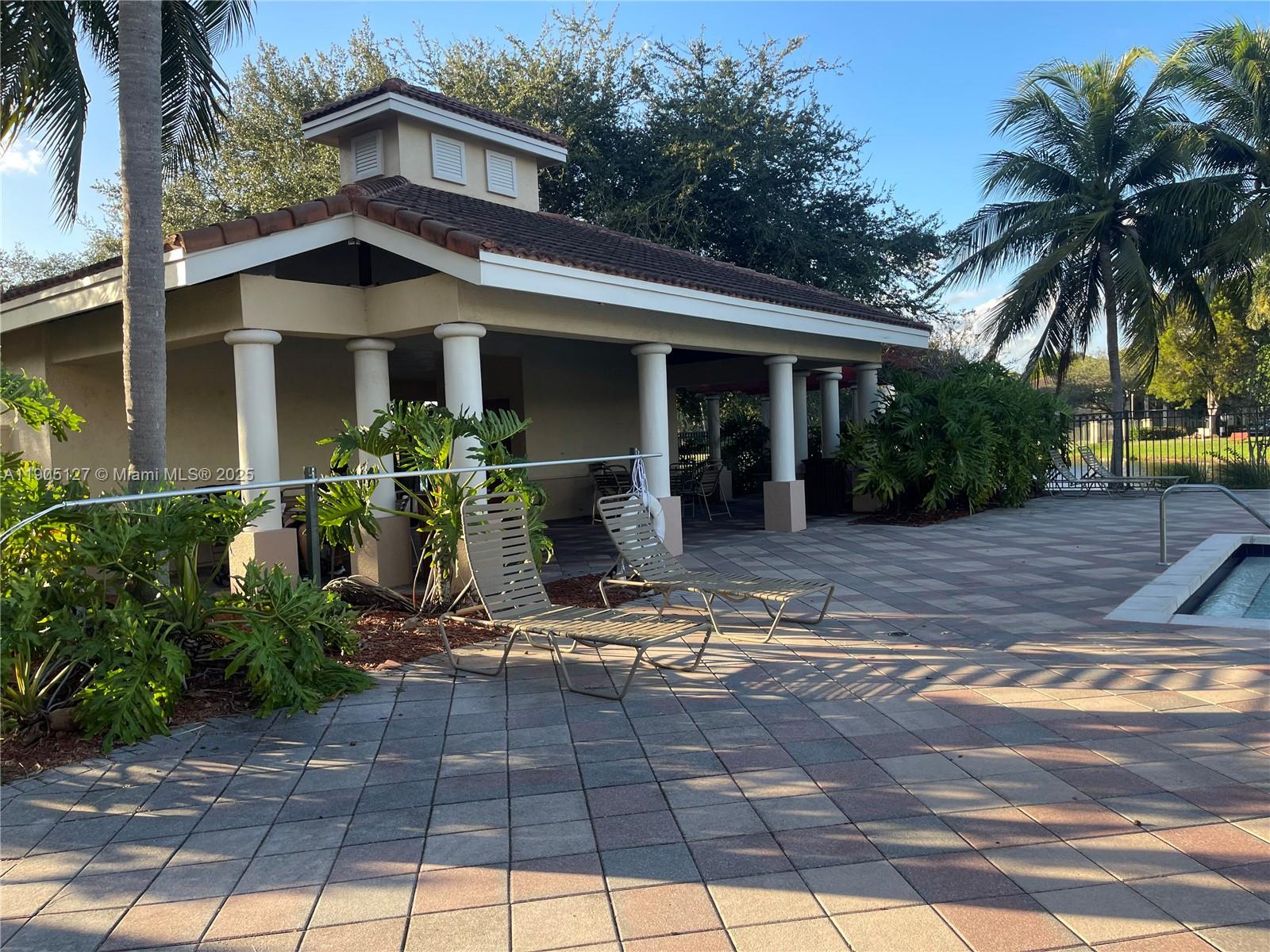 2541 Centergate Drive, Unit 205 Miramar, FL 33025 - Photo 25 of 28 a front view of a house with garden