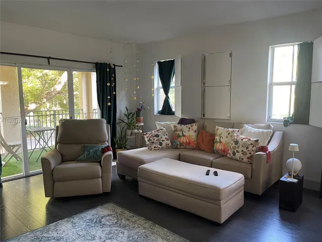 a living room with furniture and a large window