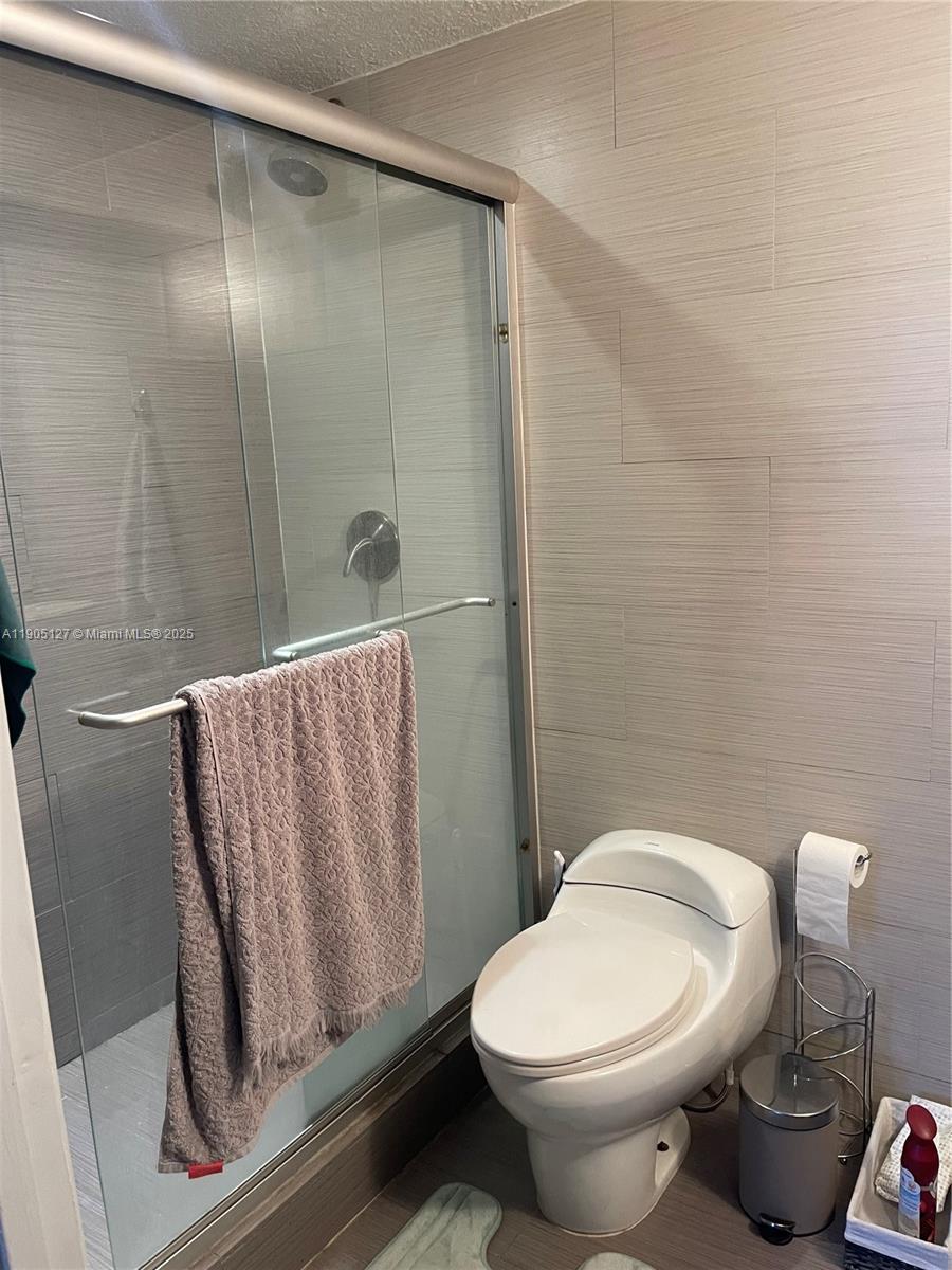 2541 Centergate Drive, Unit 205 Miramar, FL 33025 - Photo 7 of 28 a bathroom with a toilet and shower