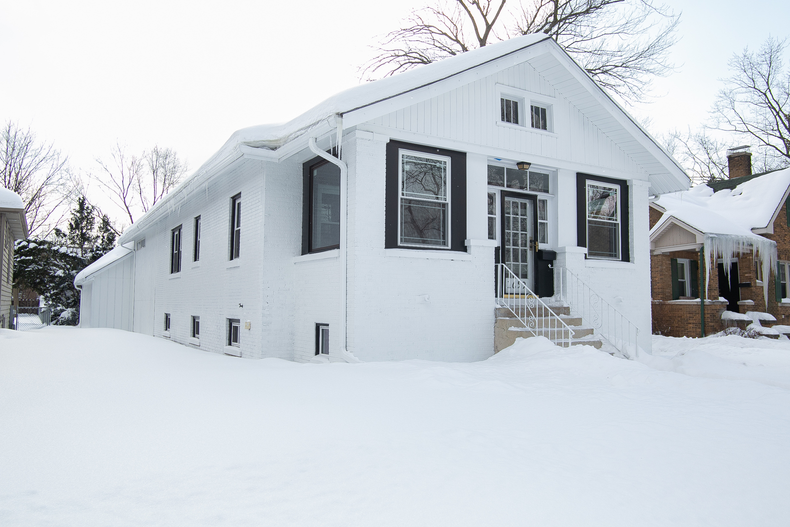 1659 Linden Road Homewood, IL 60430 - Photo 3 of 32 a view of white house with a snow in the yard