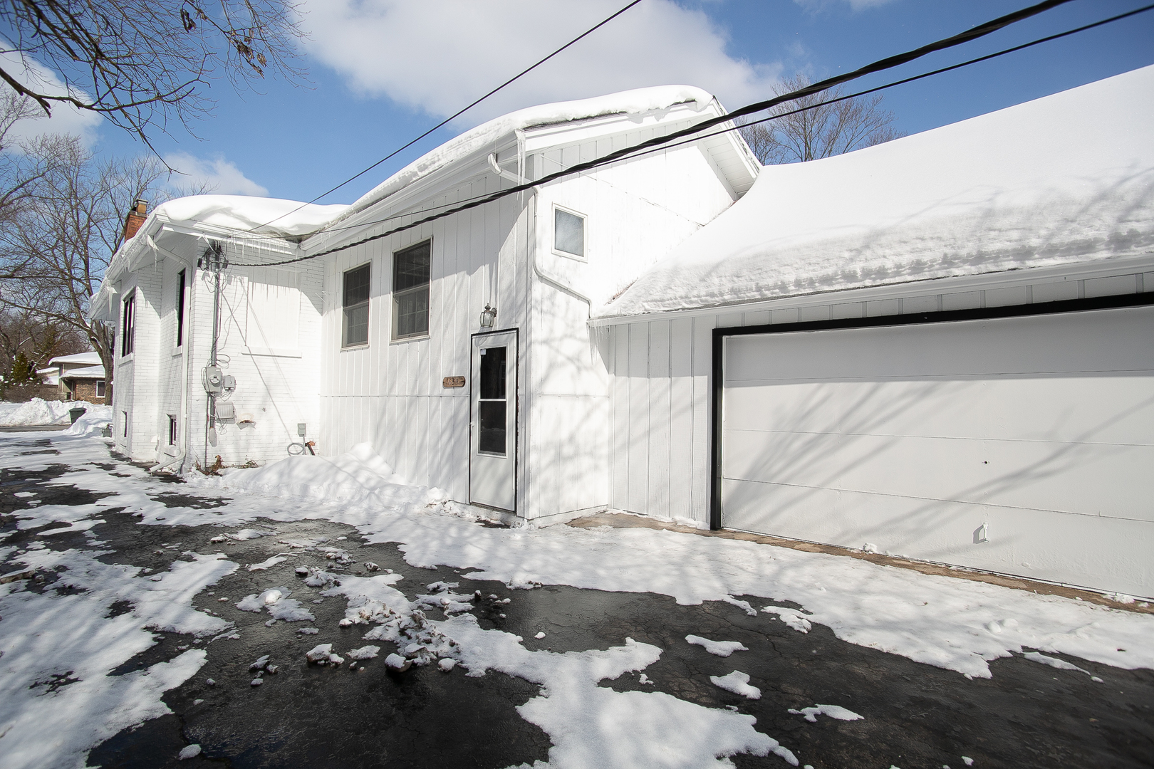 1659 Linden Road Homewood, IL 60430 - Photo 5 of 32 a view of a white house with a snow on the road