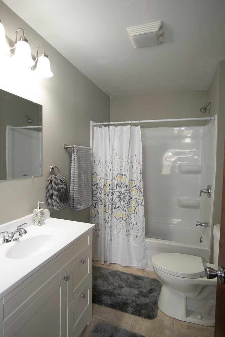 1659 Linden Road Homewood, IL 60430 - Photo 9 of 32 a bathroom with a sink a toilet and shower