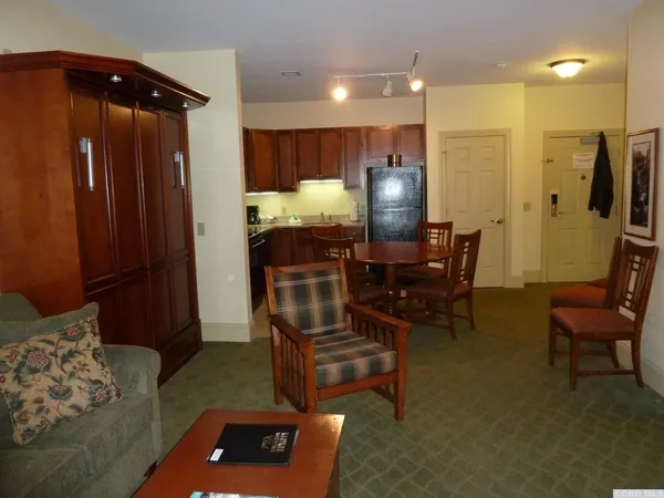 a living room with furniture and a dining table