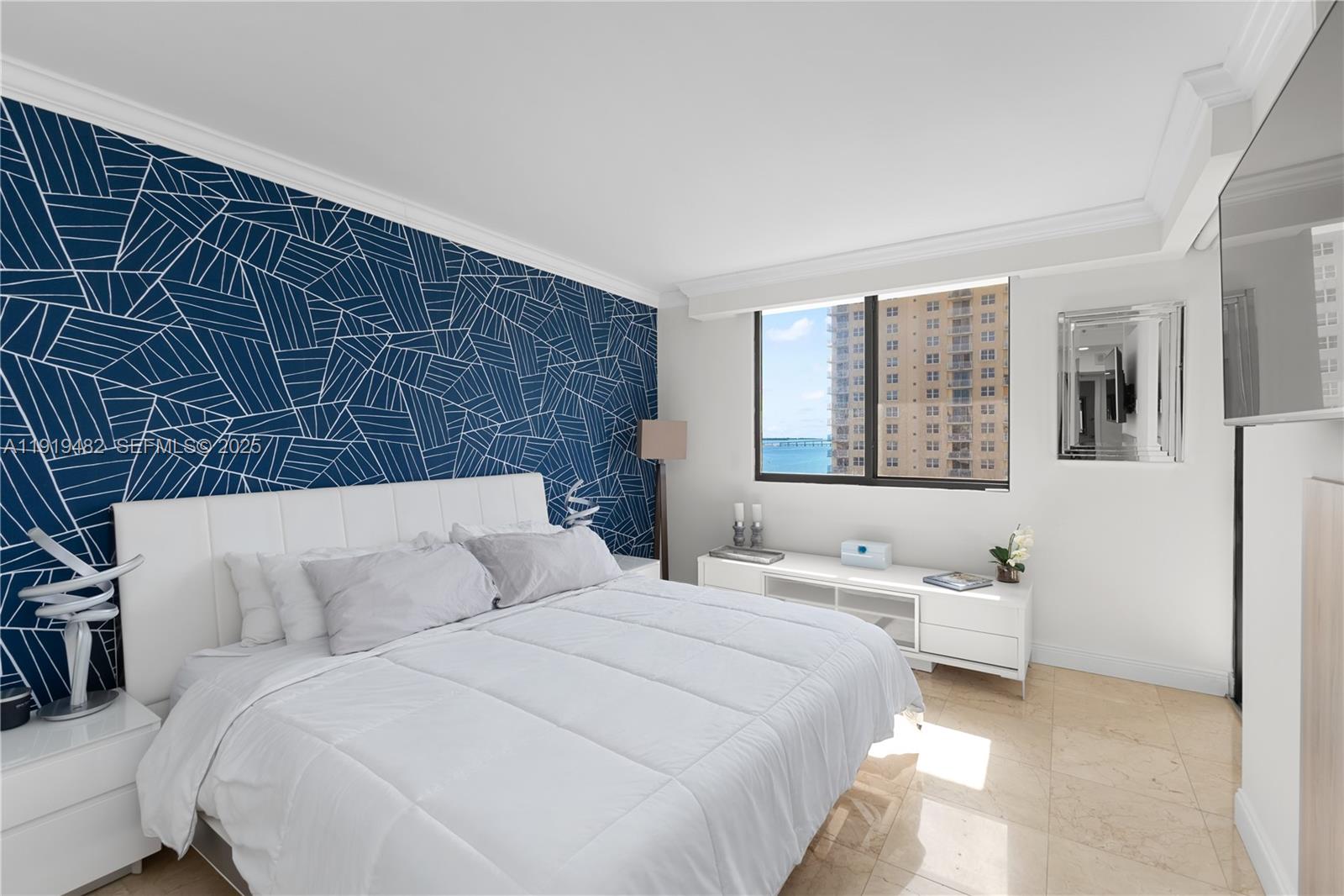 520 Brickell Key Drive, Unit A1207 Miami, FL 33131 - Photo 17 of 33 a bedroom with a bed and wooden floor