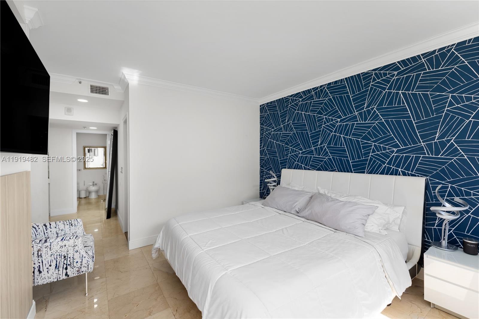 520 Brickell Key Drive, Unit A1207 Miami, FL 33131 - Photo 18 of 33 a bedroom with a bed and a television