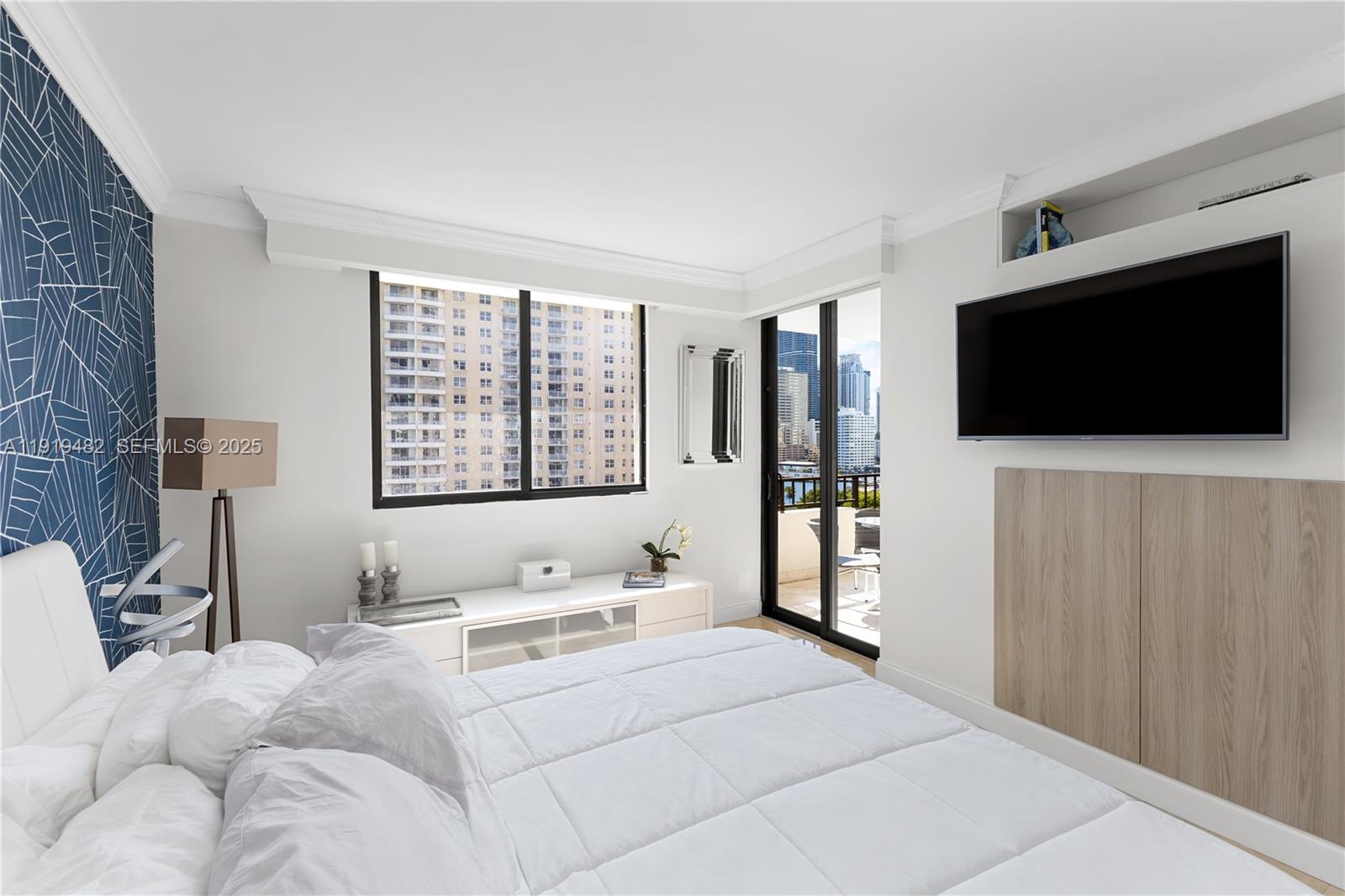 520 Brickell Key Drive, Unit A1207 Miami, FL 33131 - Photo 19 of 33 a bedroom with a bed and a flat screen tv