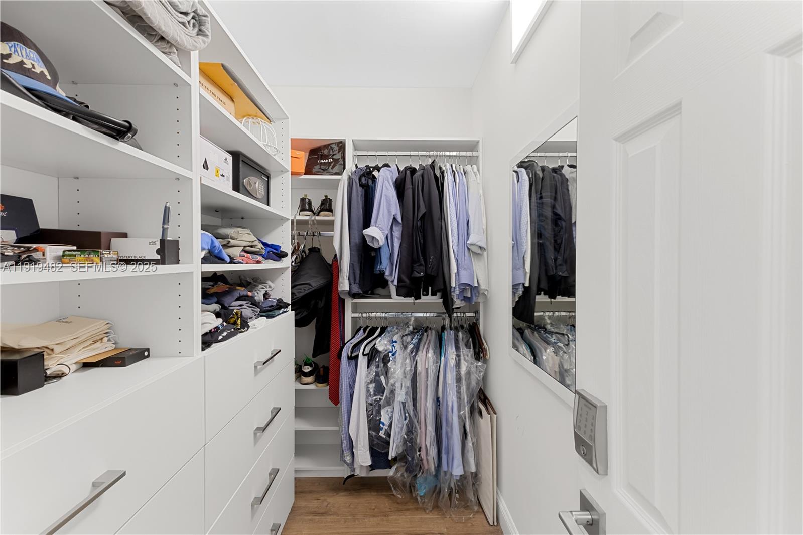 520 Brickell Key Drive, Unit A1207 Miami, FL 33131 - Photo 21 of 33 a view of walk in closet with clothes and shoes