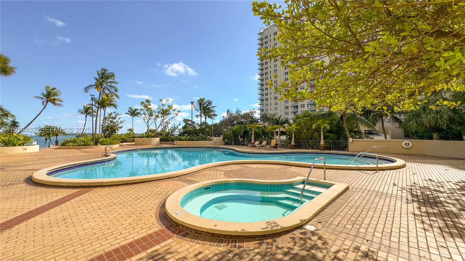 520 Brickell Key Drive, Unit A1207 Miami, FL 33131 - Photo 28 of 33 a view of a swimming pool with a yard and plants