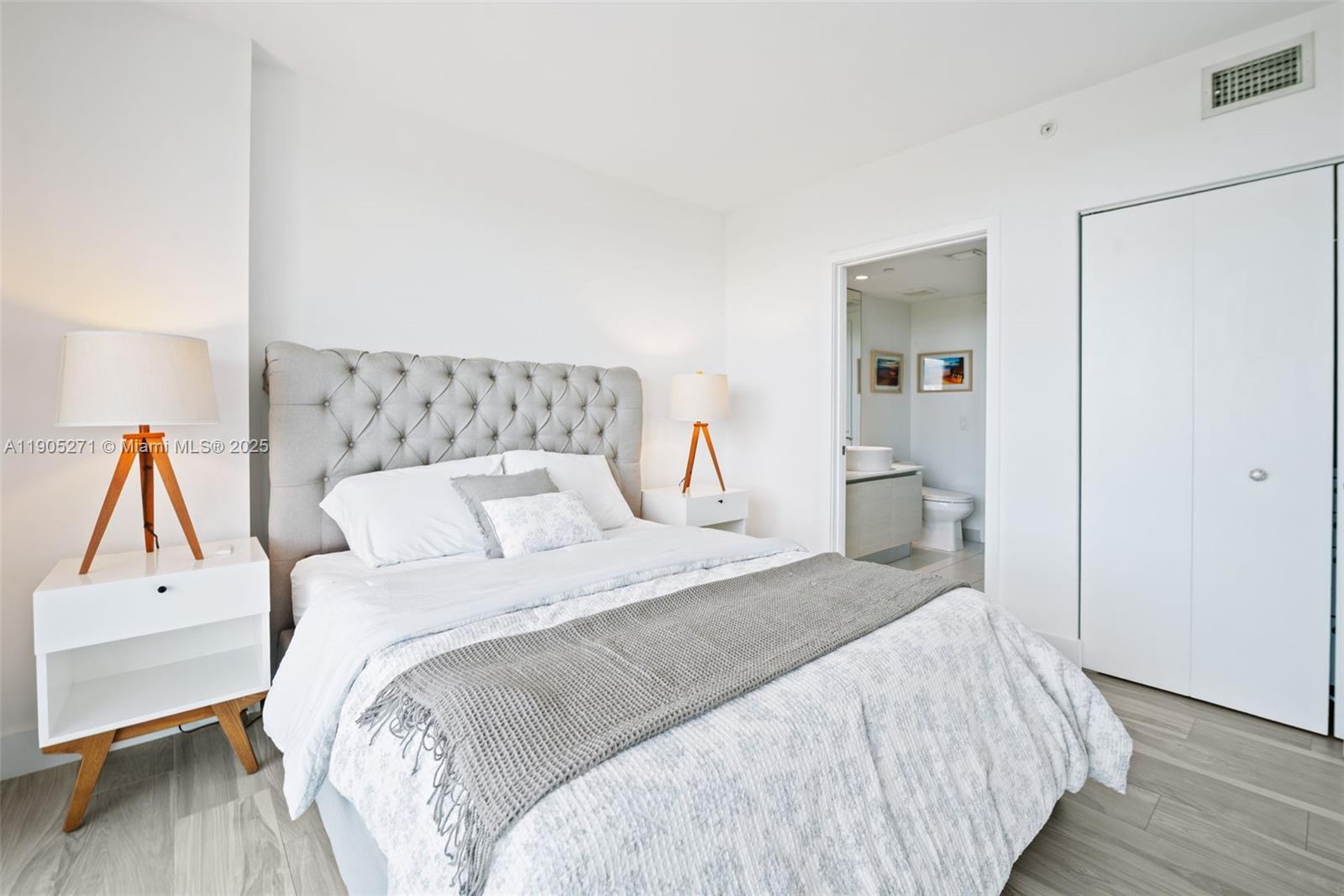 4250 Biscayne Boulevard, Unit 1009 Miami, FL 33137 - Photo 11 of 23 a bedroom with a bed and wooden floor