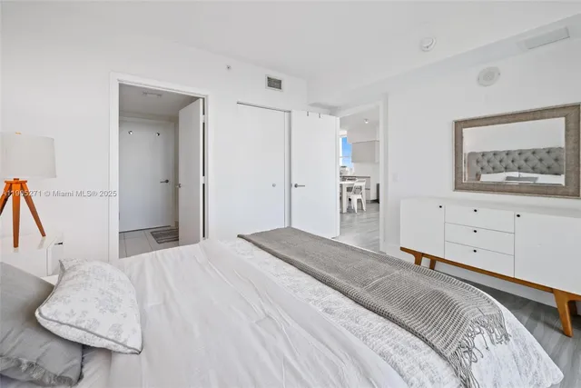 a bedroom with a bed and a couch