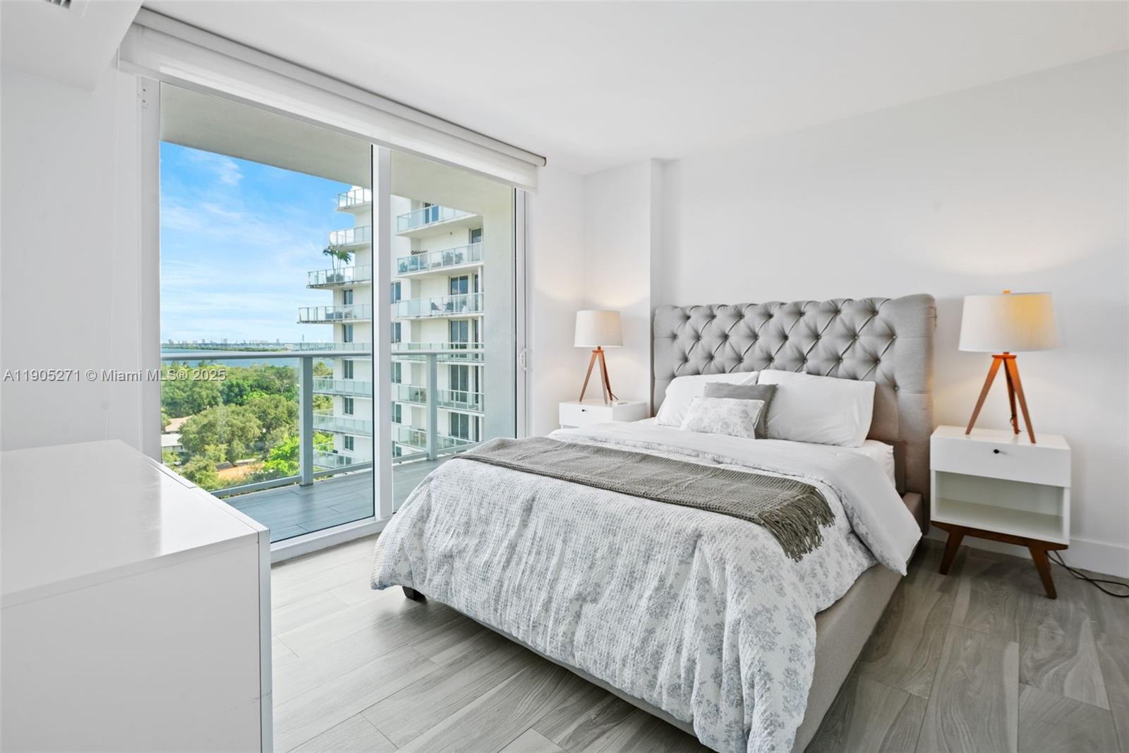 4250 Biscayne Boulevard, Unit 1009 Miami, FL 33137 - Photo 13 of 23 a bed sitting in a bedroom next to a window