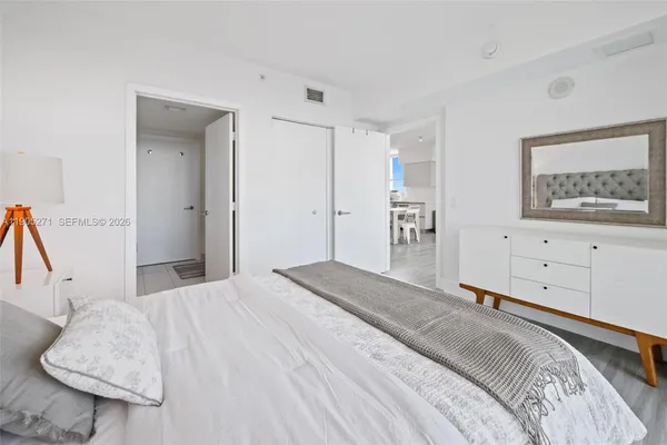 a bedroom with a bed and a couch