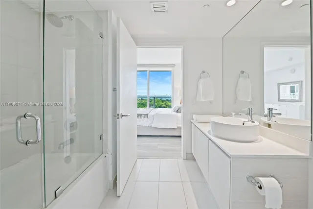 a bathroom with a tub sink and mirror