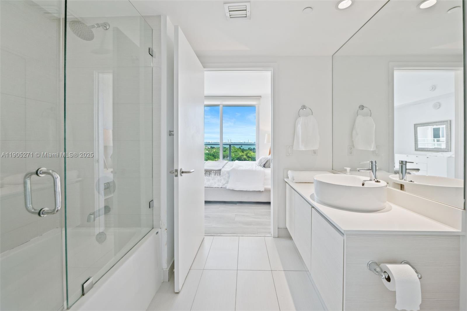 4250 Biscayne Boulevard, Unit 1009 Miami, FL 33137 - Photo 15 of 23 a bathroom with a tub sink and mirror