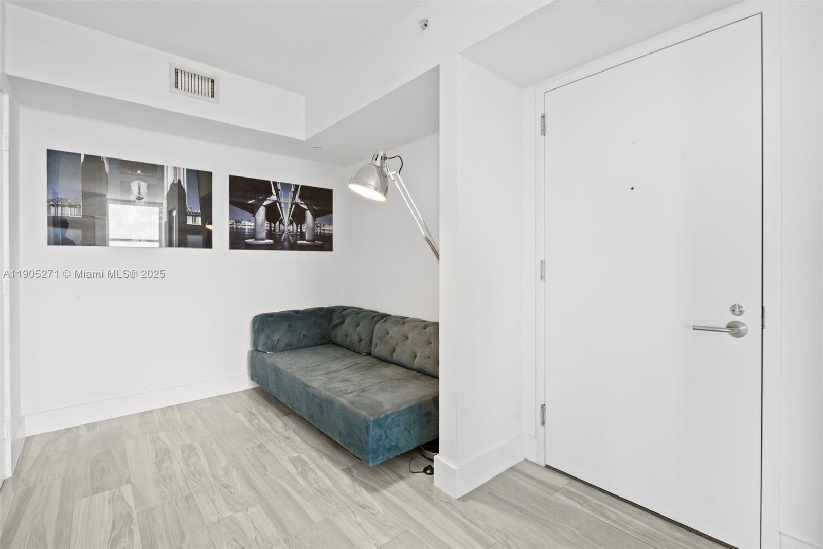 4250 Biscayne Boulevard, Unit 1009 Miami, FL 33137 - Photo 19 of 23 a living room with furniture and a wooden floor