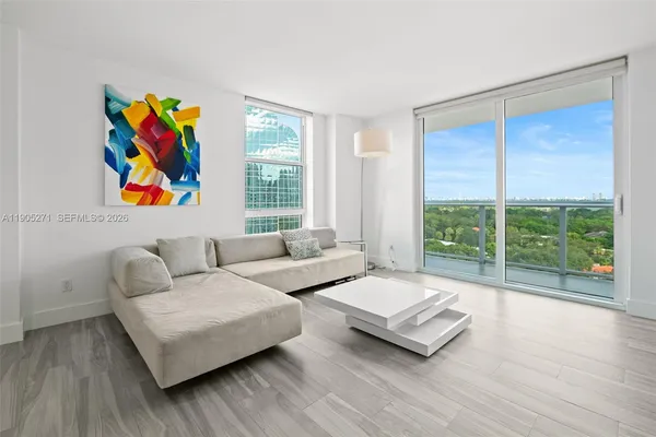a living room with furniture and a large window