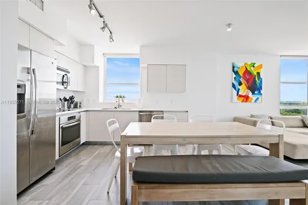 a kitchen with a sink appliances and cabinets