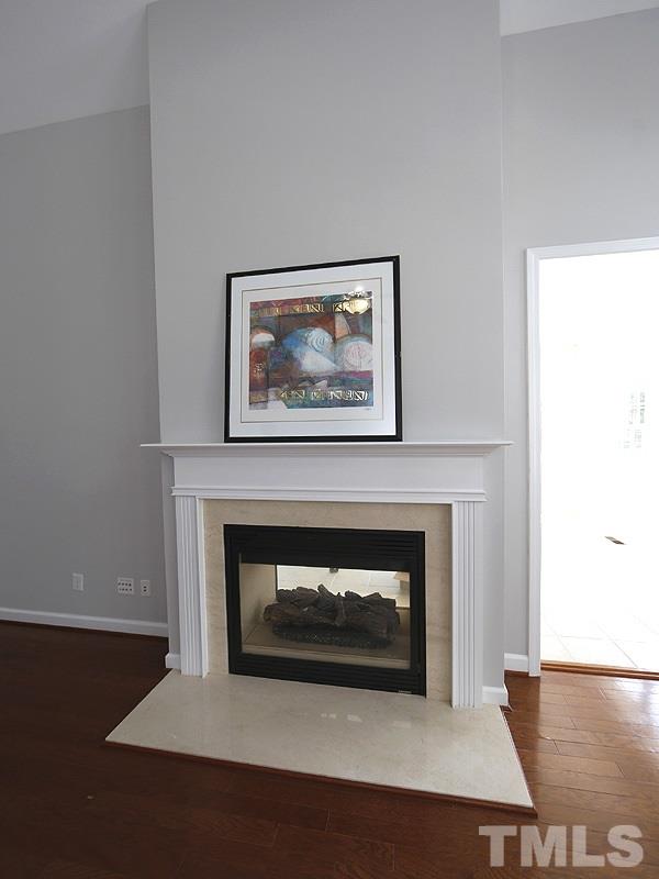 3324 Queensland Road Raleigh, NC 27614 - Photo 12 of 25 The fireplace goes through to the sunroom. Multi-media outlets are above and beside the fireplace.