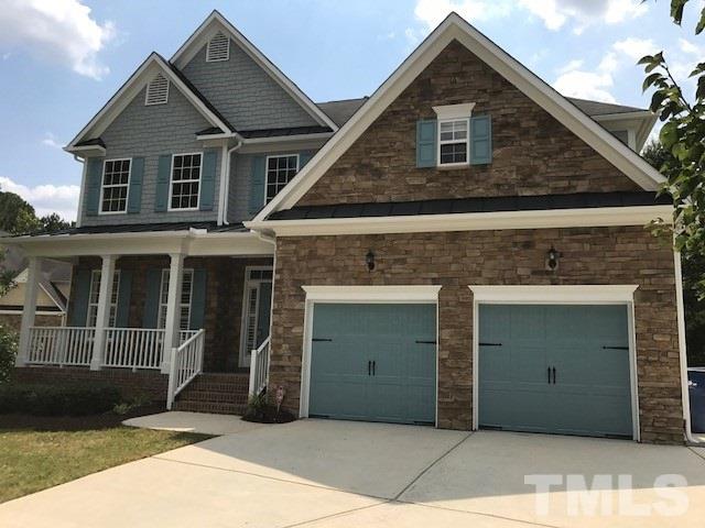 3324 Queensland Road Raleigh, NC 27614 - Photo 2 of 25 An extra large parking pad with room for a car on the side, leads to the 2 car garage. There is currently a handicapped elevator lift in the garage that can remain or be removed by the seller.