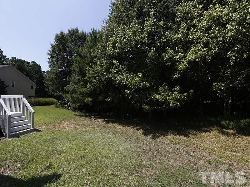 3324 Queensland Road Raleigh, NC 27614 - Photo 23 of 25 The tree-lined backyard has a great blend of sun and shade with room to play.