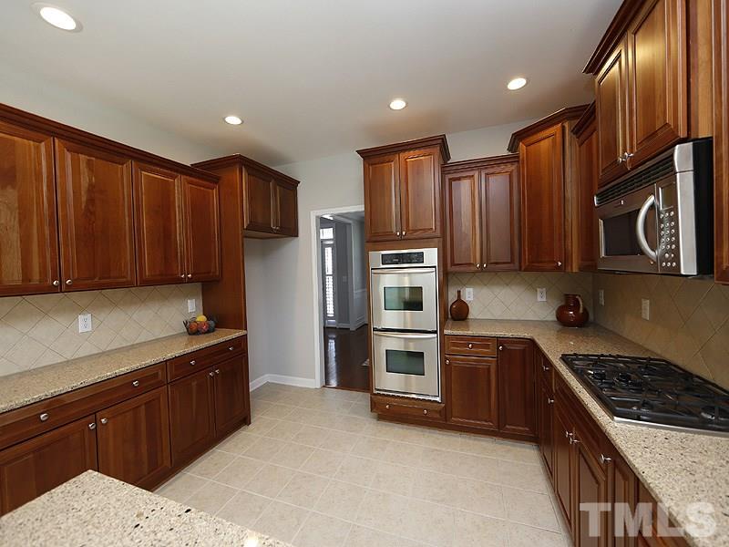 3324 Queensland Road Raleigh, NC 27614 - Photo 5 of 25 What a wonderful kitchen to work in..tons of cabinet and counter space, double ovens, gas cooktop with microwave above....there is a double door pantry and lots of natural light.