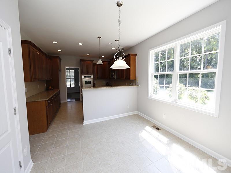 3324 Queensland Road Raleigh, NC 27614 - Photo 8 of 25 The light filled breakfast room is open to the kitchen and also the sunroom.
