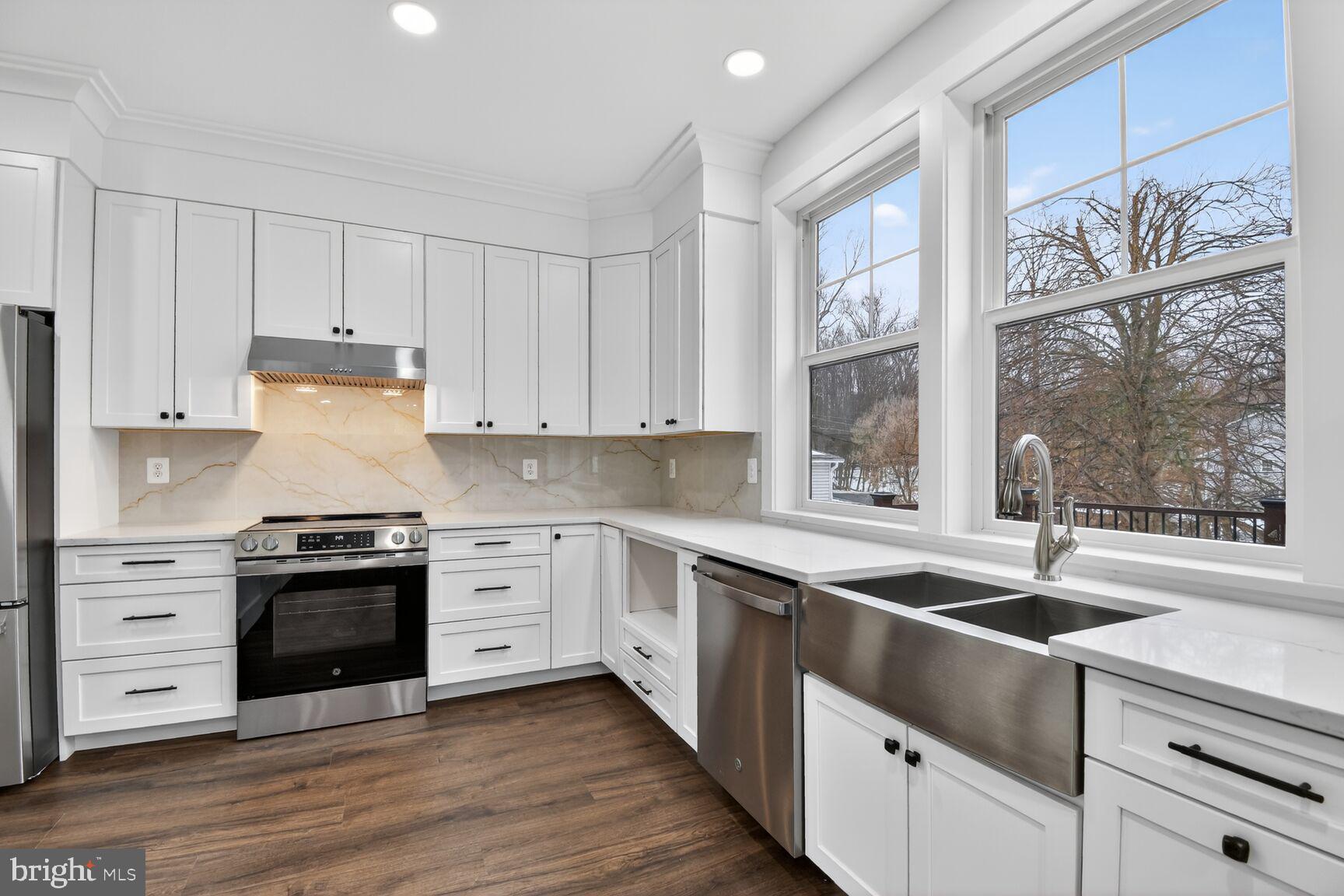 13102 Ideal Drive Silver Spring, MD 20906 - Photo 12 of 48 a kitchen with stainless steel appliances white cabinets and a granite counter tops