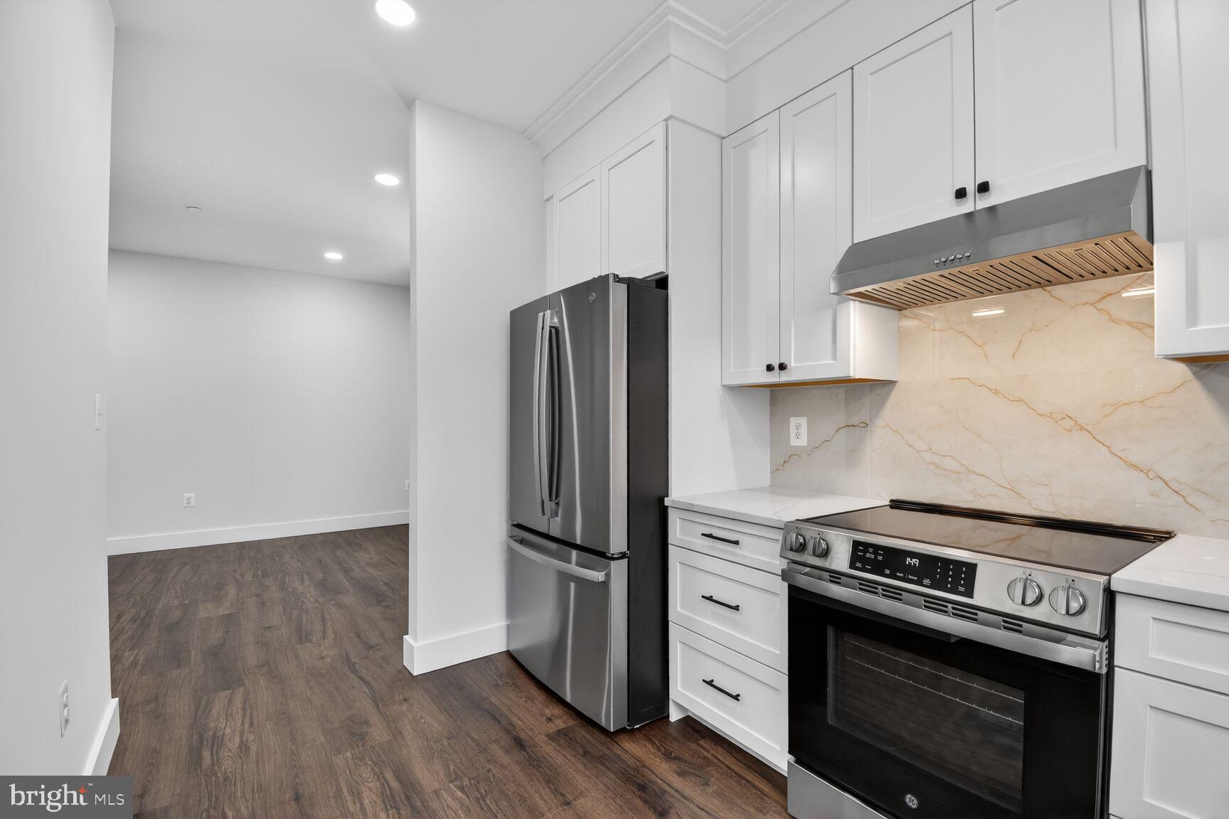13102 Ideal Drive Silver Spring, MD 20906 - Photo 13 of 48 a kitchen with a stove and a refrigerator