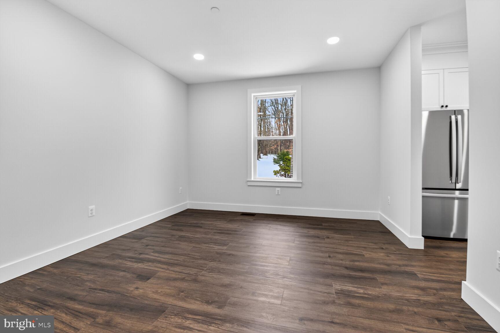 13102 Ideal Drive Silver Spring, MD 20906 - Photo 16 of 48 an empty room with wooden floor and a window