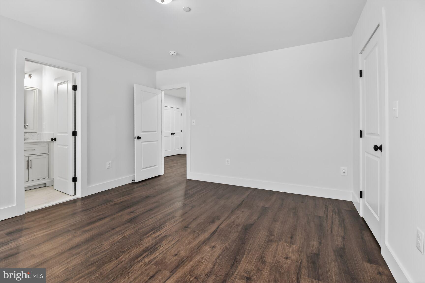13102 Ideal Drive Silver Spring, MD 20906 - Photo 18 of 48 a view of an empty room with wooden floor and white doors